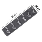 Elegant golden and transparent 6-pin hooks providing storage on a bathroom wall.