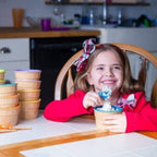 Kids enjoying desserts from the colourful ice cream bowls at a party