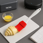 Silicone spatula and pastry brush in use for intricate cake decoration.