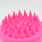 Scalp cleansing brush with ergonomic handle for deep hair wash.