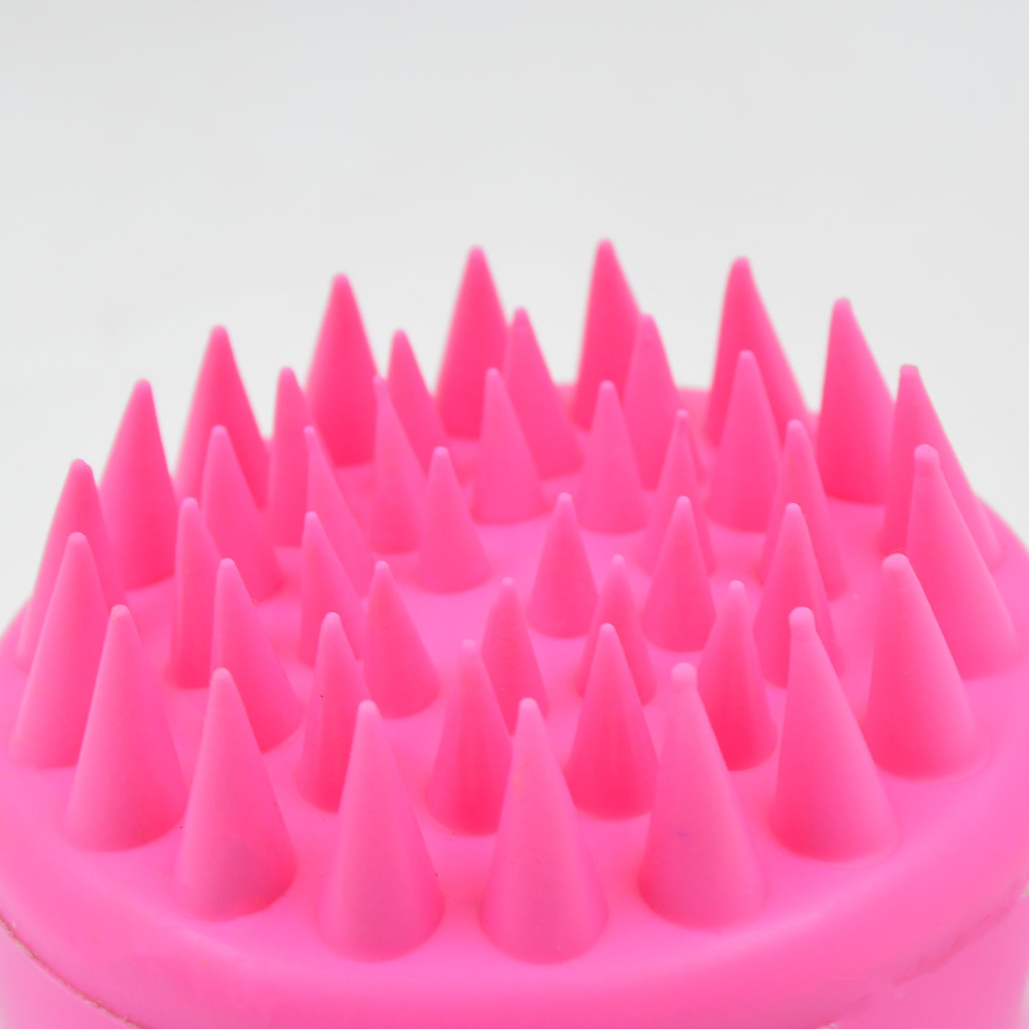 Scalp cleansing brush with ergonomic handle for deep hair wash.
