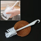 Cleaning brush with white handle and sturdy bristles for kitchen use