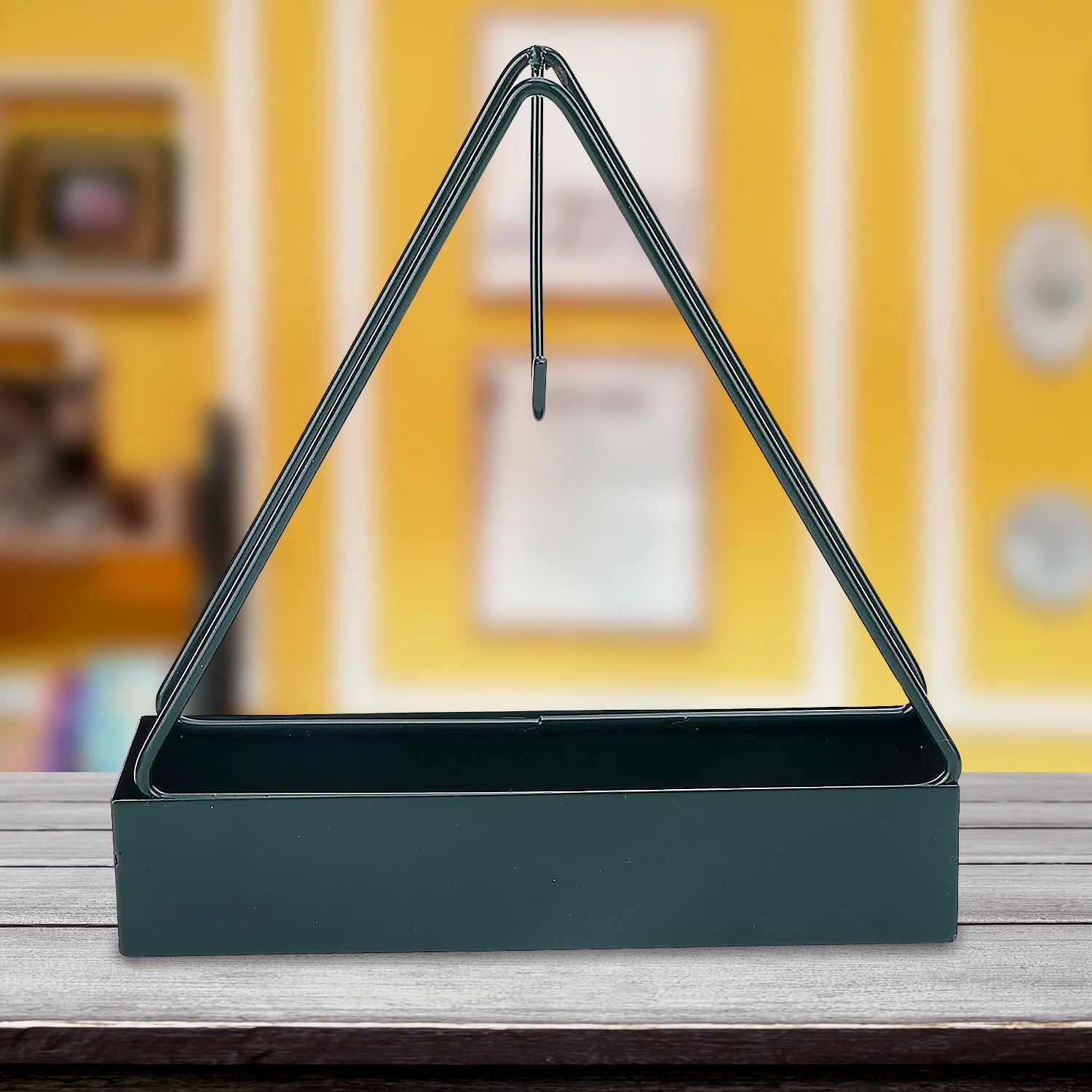Stylish triangular mosquito coil holder hanging on a rustic wooden wall.
