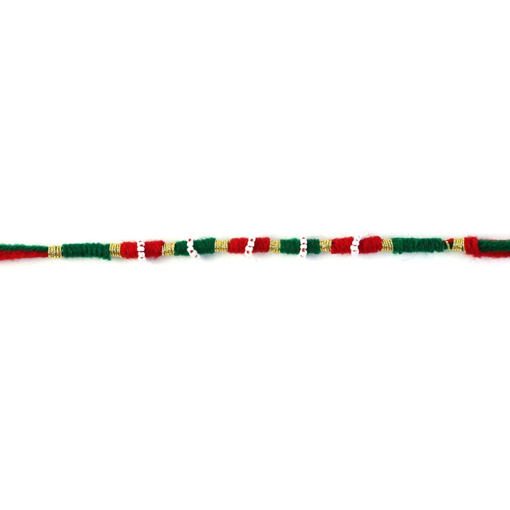 Red green and gold wire rakhi showcasing decorative craftsmanship