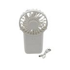 Mini electric fan standing on a desk next to a laptop, ideal for office or study.
