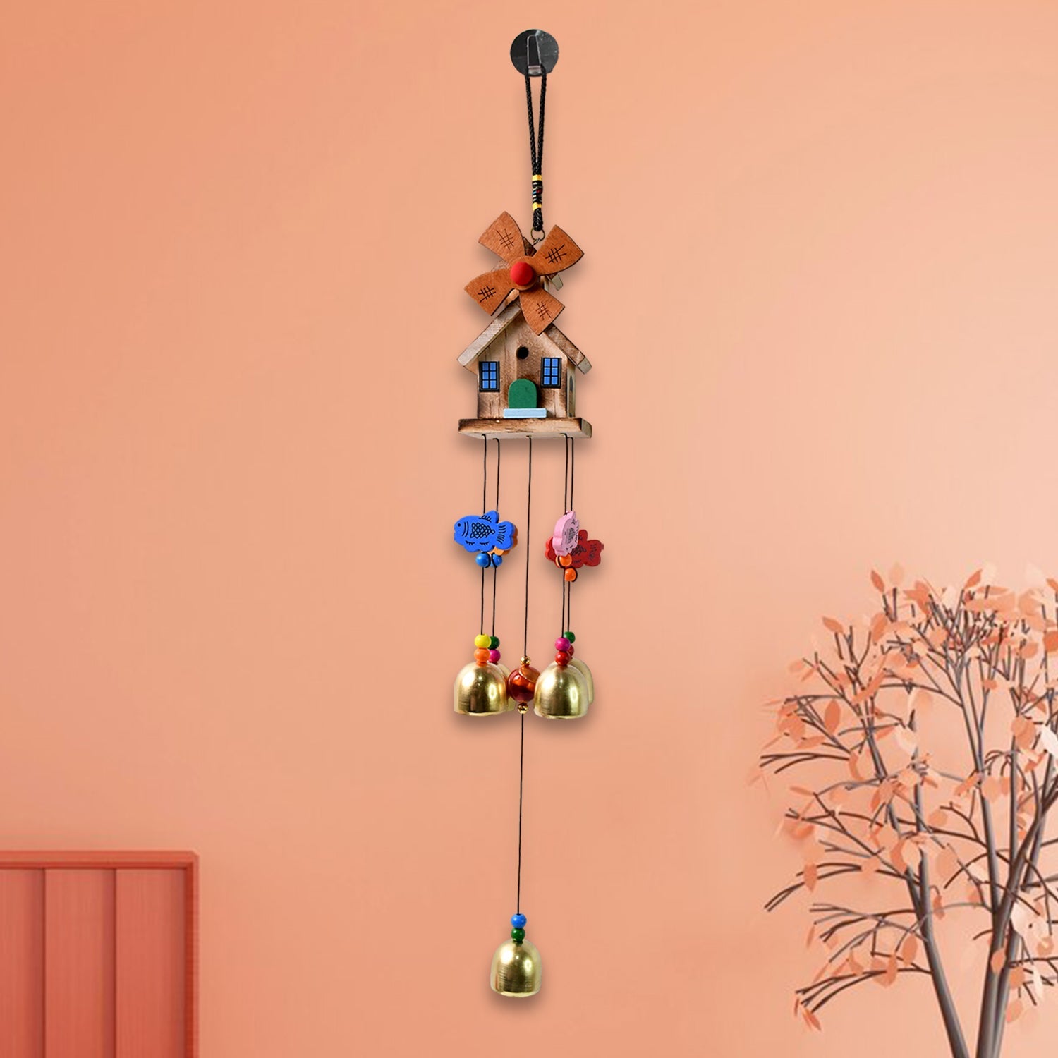 Vivid dragonfly wind chime hanging outdoors catching sunlight
