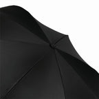 Kids umbrella compactly folded with a secure carrying strap.