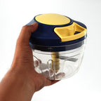 Hand operating the pull-cord mechanism of the manual vegetable chopper.