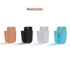 Wall organizer box holding a remote control and a mobile phone.