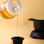 Durable plastic oil dispenser bottle for everyday kitchen use.