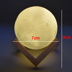 The 3D moon lamp illuminated, highlighting its spherical shape and touch-sensitive controls.