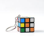 Close-up of a Mini Magic Cube Puzzle keychain on a clean white background.