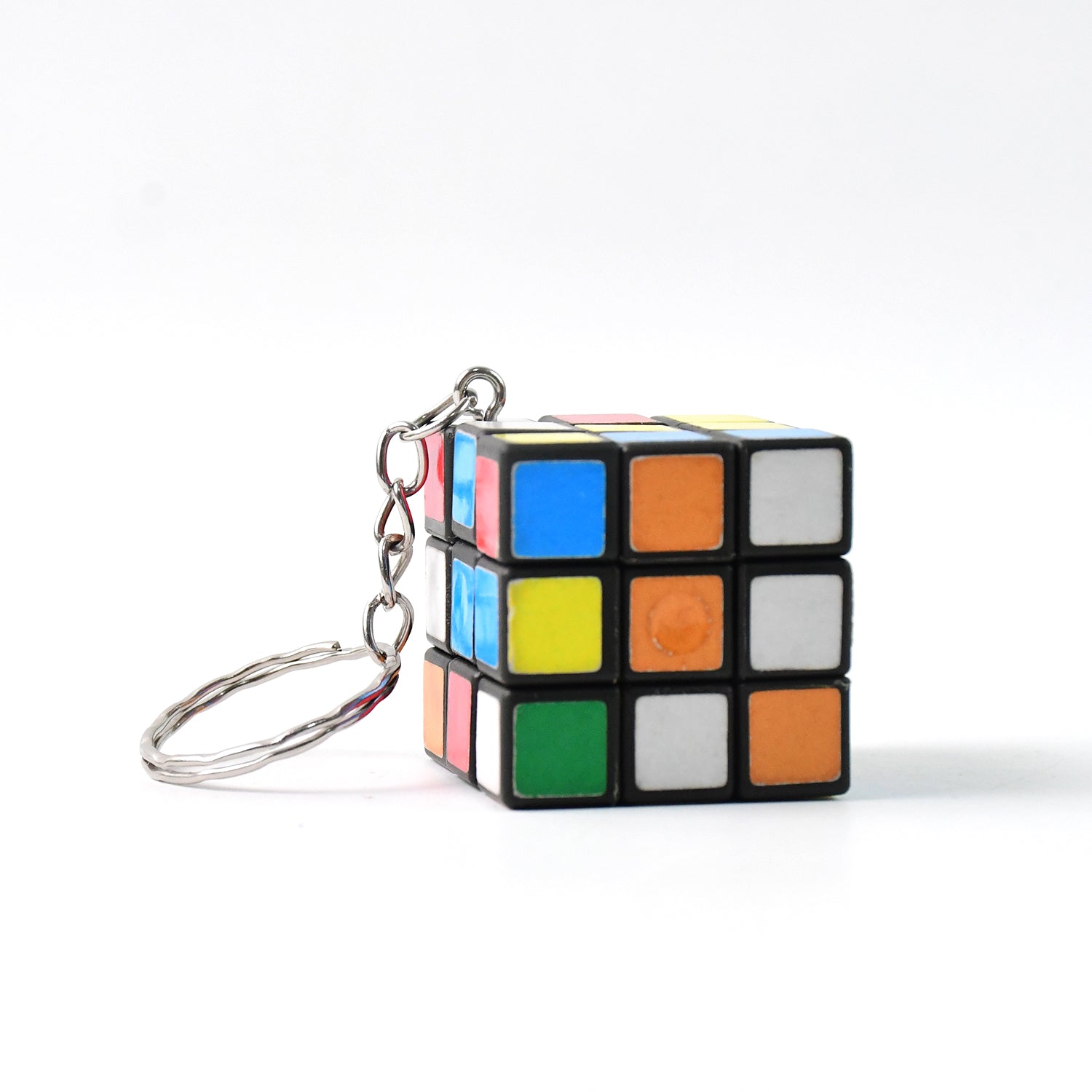 Close-up of a Mini Magic Cube Puzzle keychain on a clean white background.
