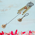 Vivid dragonfly wind chimes hanging outdoors in sunlight