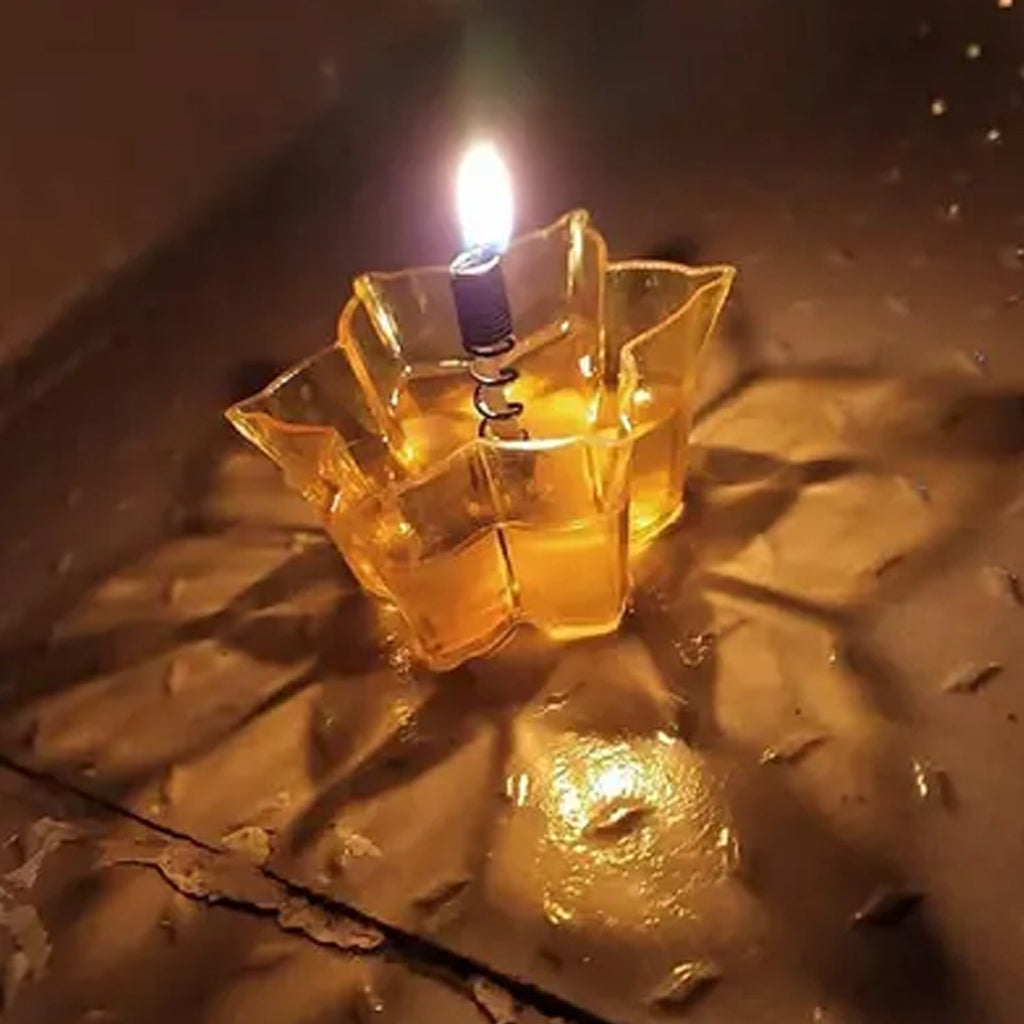 Several unlit reflection diyas neatly stacked, highlighting their golden finish and intricate details.