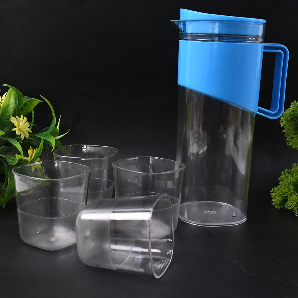 Serving water from transparent stylish jug with elegant handle