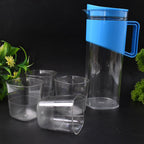 Serving water from transparent stylish jug with elegant handle