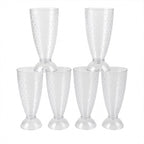Transparent plastic milkshake glasses neatly arranged on a dining table