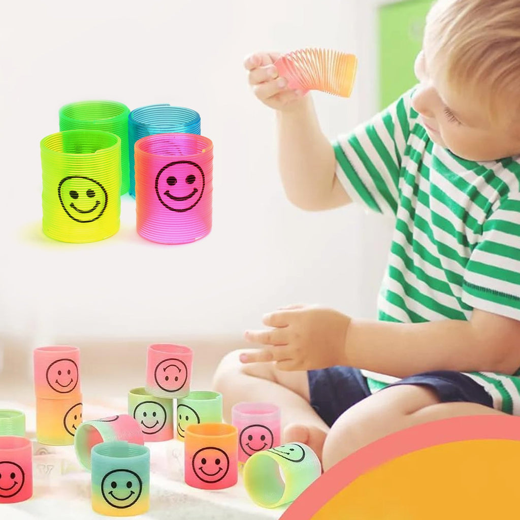 A collection of colorful slinky spring toys scattered on a clean surface.