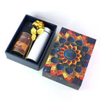 Luxury designer gift box containing coffee almonds chocolate, golden rose, and bottle