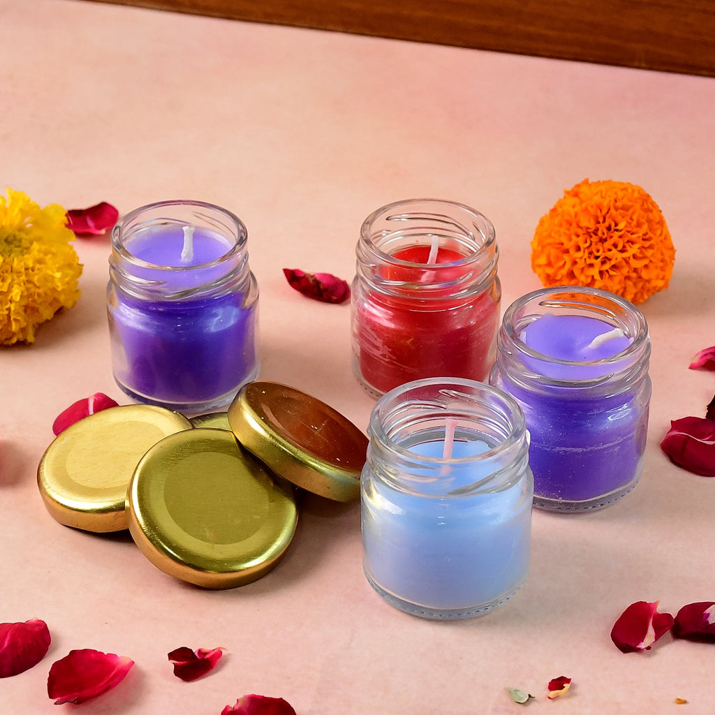 Wax candle set showcasing colorful decorative glass jar candles with gold lids