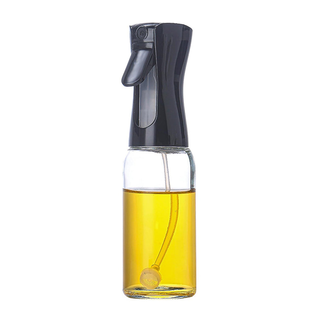 Clear glass oil mister with a comfortable ergonomic grip.