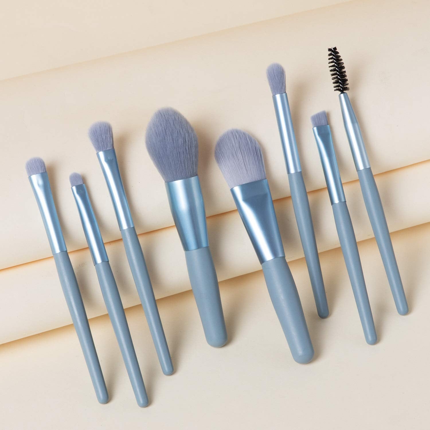 A single foundation brush from the mini makeup brush set, highlighting its dense synthetic bristles.