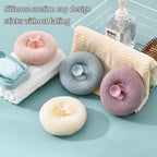The convenient flower bath sponge hanging neatly by its suction cup in a bathroom.