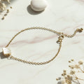 Close-up of adjustable chain bracelet with elegant square stone charm