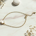 Close-up of adjustable chain bracelet with elegant square stone charm