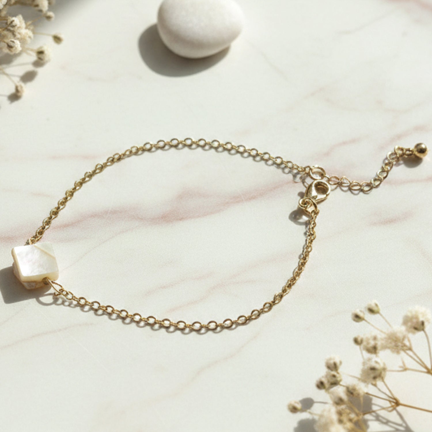 Close-up of adjustable chain bracelet with elegant square stone charm