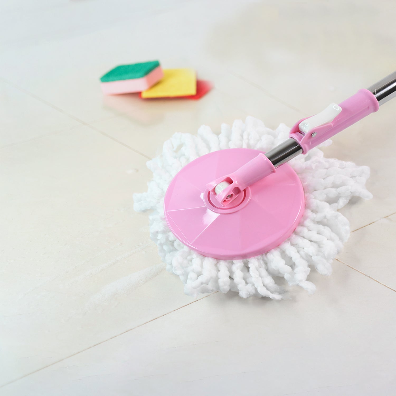 360° rotating mop head effortlessly cleaning a tiled floor surface.