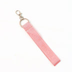 Metal ring of key holder attached to Girl Power fabric ribbon keychain