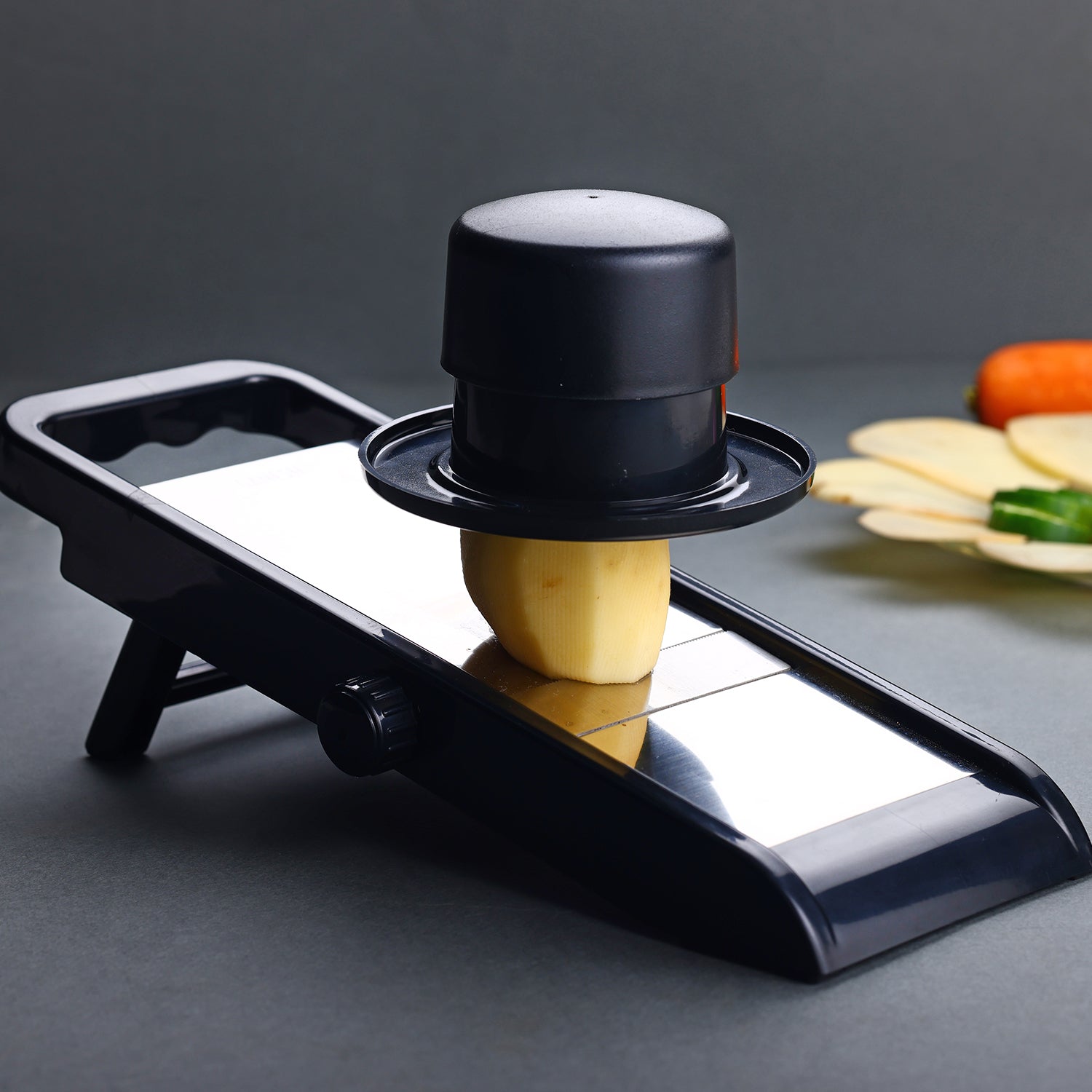 Ergonomic handle and durable spikes of the Ganesh adjustable vegetable slicer.