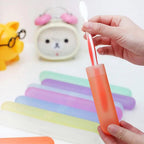 Hand holding a set of lightweight and portable toothbrush covers.