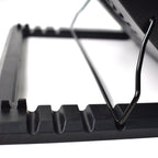 Laptop cooling fan pad with blue LED lights, enhancing the gaming setup.