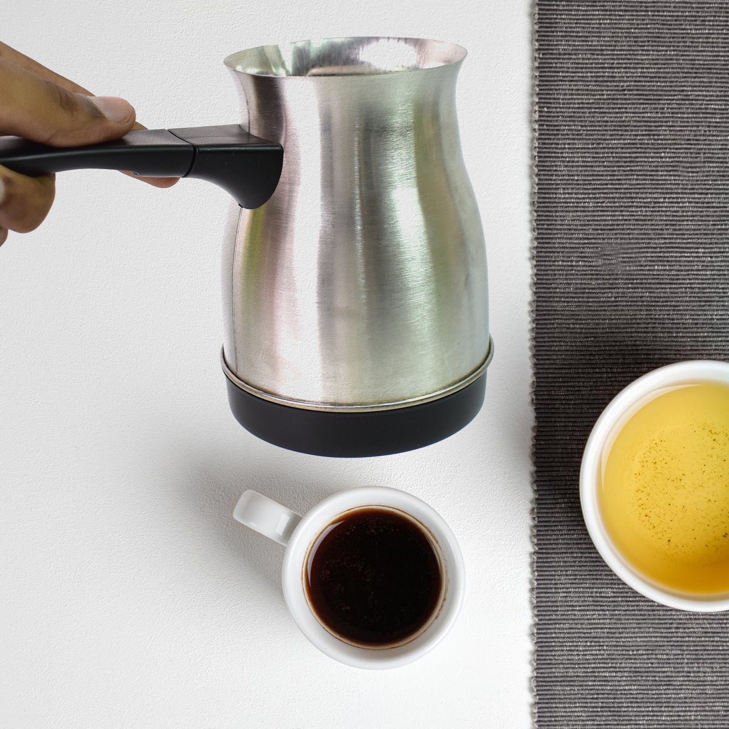 A cup of freshly brewed coffee next to the 800ml Electric Coffee Maker, emphasizing its quick brewing.