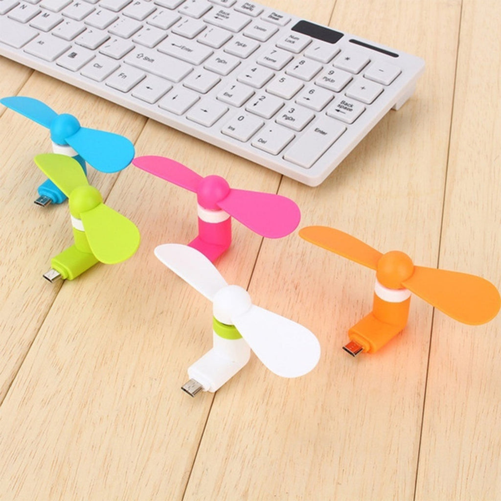 Mini USB fan providing gentle air circulation on a desk.