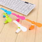 Mini USB fan providing gentle air circulation on a desk.