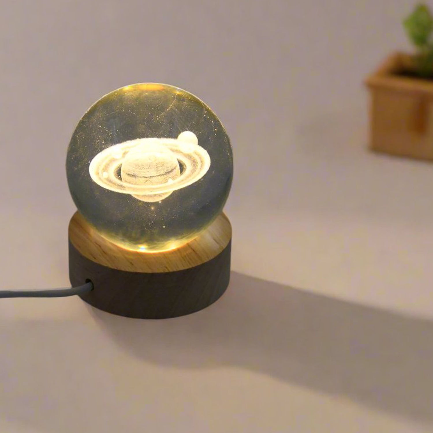 Overhead view of the astronaut crystal lamp with its elegant wooden stand.