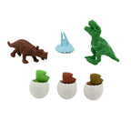 Children happily using colorful dinosaur puzzle erasers at a school desk.