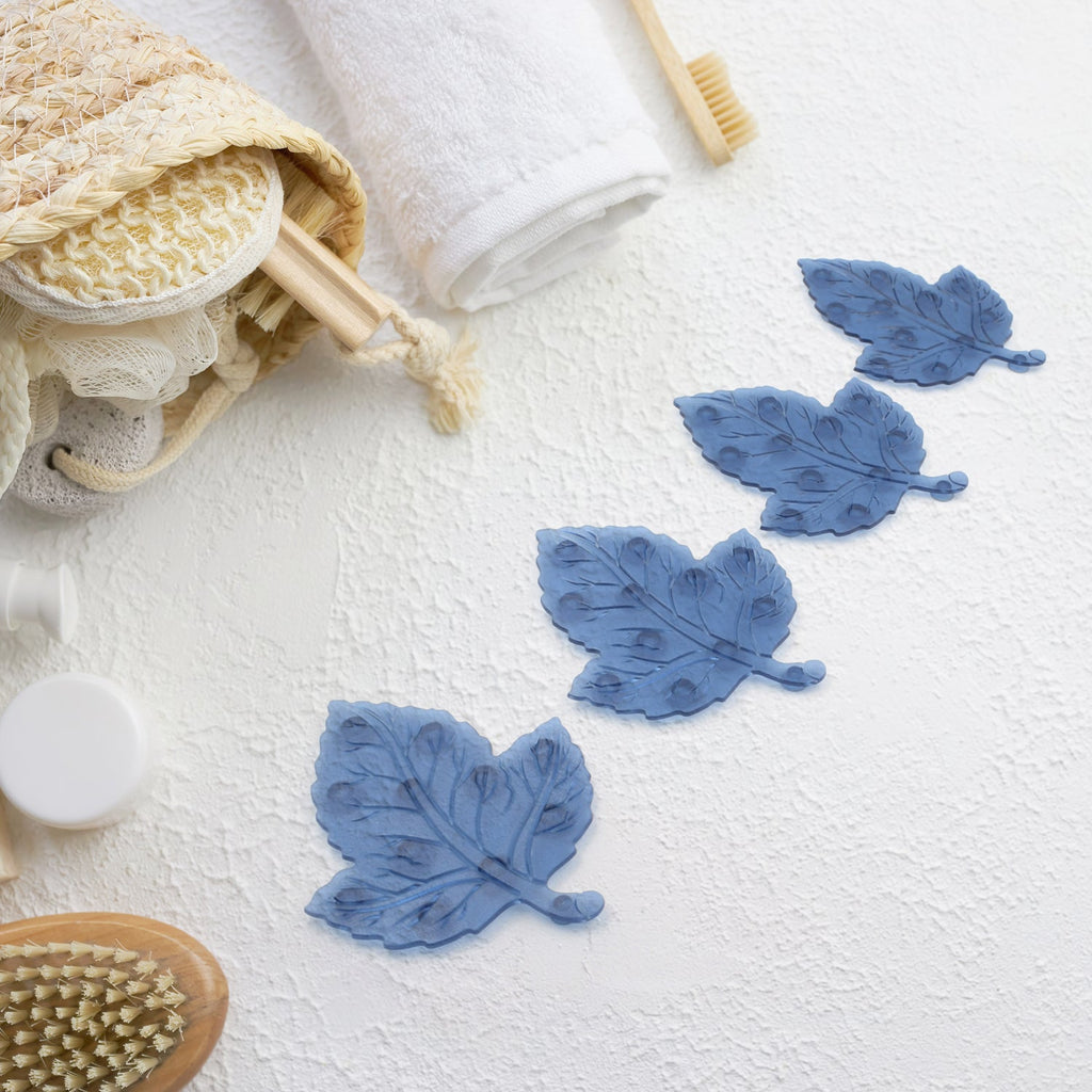 Four colorful leaf-shaped baby anti-slip bath mats with suction cups displayed.