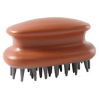 Person holding scalp massage brush during hair wash with soft bristles