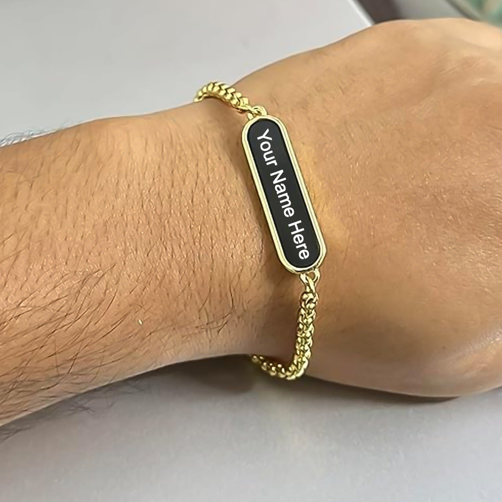 Golden bracelet with custom engraving on a display.
