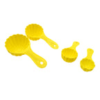 Four different plastic ladoo moulds arranged neatly on a surface.