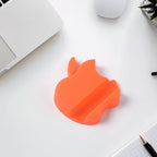 Apple-shaped plastic phone stand holding smartphone in landscape view