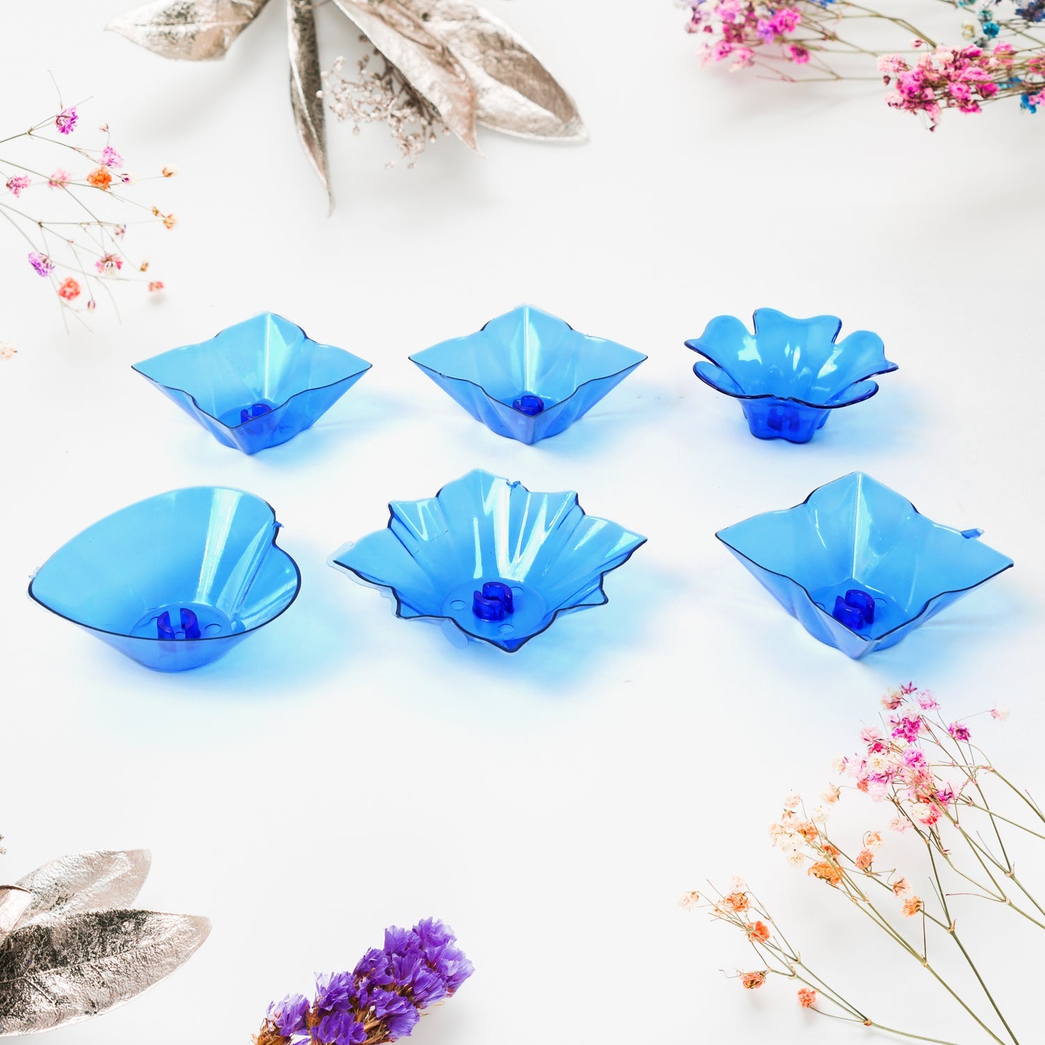 The elegant plastic candle holders from the Diwali Diya Set displayed on a surface.