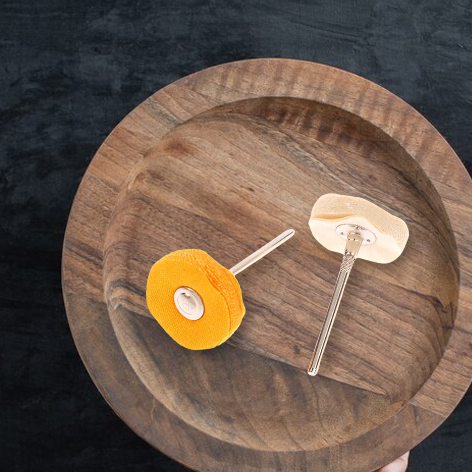 Polishing wheel attached to a Dremel tool, ideal for jewelry buffing.