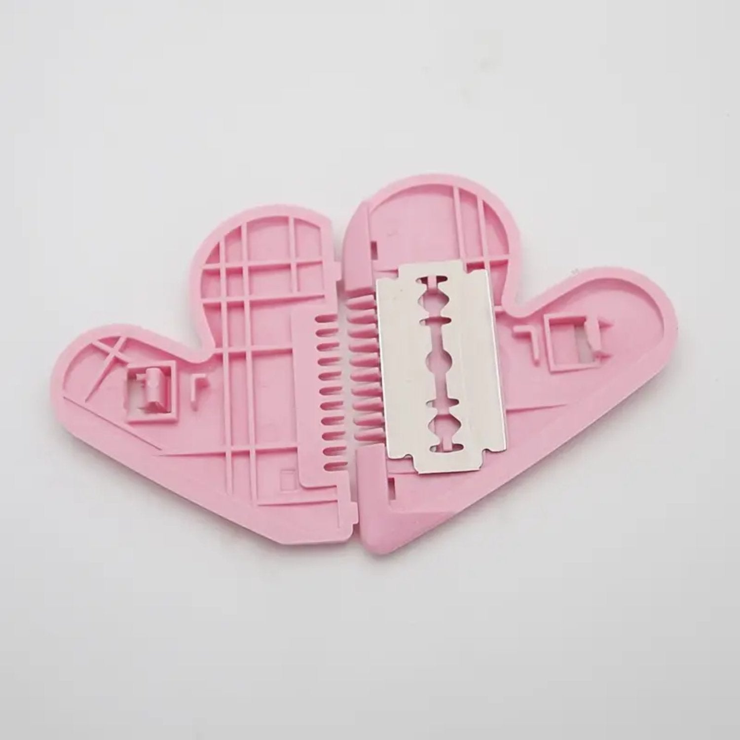 Heart-shaped safety trimming scissors on a clean surface