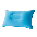 Compact inflatable travel pillow folded and ready to pack for travel